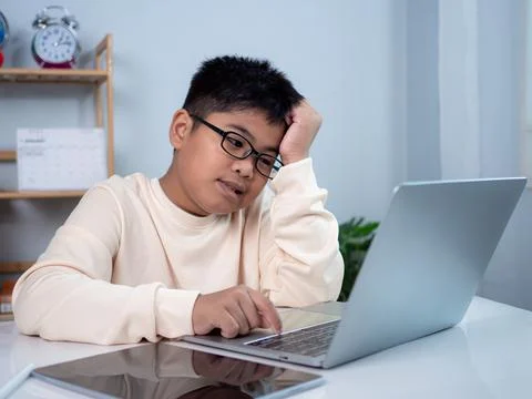 Boy using computer for learning and stressed about online learning, Virtual.. Stock Photos