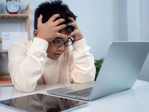 Boy using computer for learning and stressed about online learning, Virtual.. Stock Photos