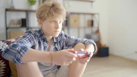  Boy using the Controller playing Online Video Game  Stock Footage 126904311