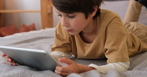 Boy using digital tablet on bed Stock Footage 145236105