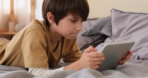 Boy using digital tablet on bed Stock Footage 145236274