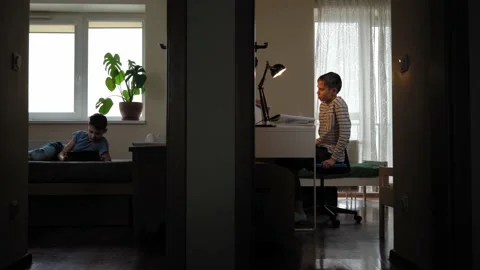 Boy using digital tablet in bedroom. Teenage boy have difficulties with homework Stock Footage 151917809