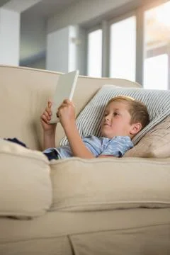 Boy using digital tablet in the living room Stock Photos