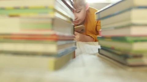  boy using digital tablet video messaging in bed  Stock Footage 84314137