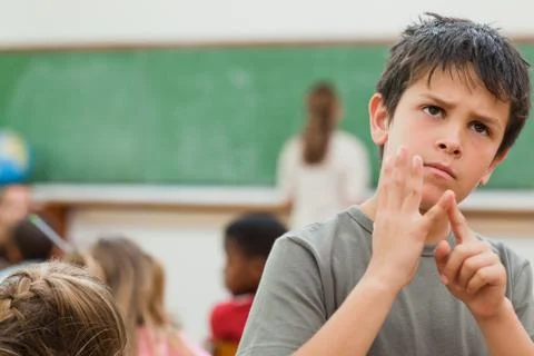 Boy using his fingers to do math Foto stock
