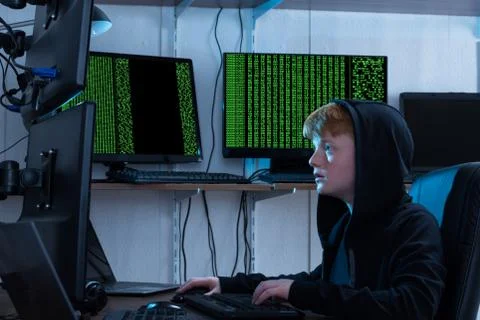 Boy Using Keyboard While Stealing Information From Multiple Computers 스톡 사진