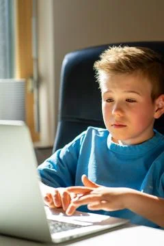 Boy using a laptop and study online with video call teacher at home. Learning Stock Photos