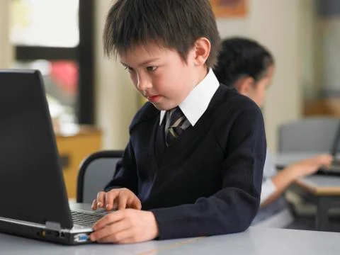 Boy Using Laptop In Class Stock Photos