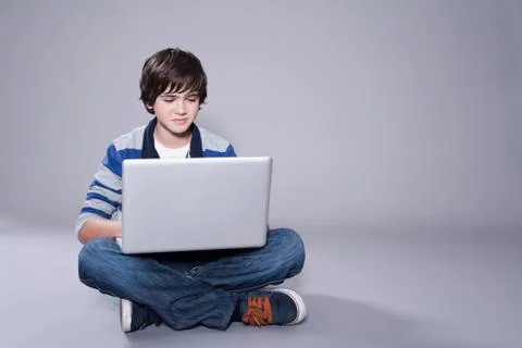 Boy using laptop Stock Photos