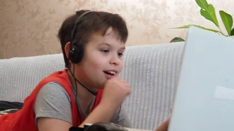 Boy using a laptop playing online games or tablet communicate blogging, studying 库存影片 148631655