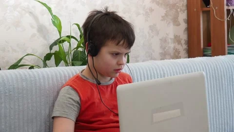 Boy using a laptop playing online games or tablet communicate blogging, studying 库存影片 148631961