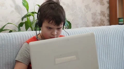 Boy using a laptop playing online games or tablet communicate blogging, studying 库存影片 148632020