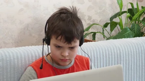 Boy using a laptop playing online games or tablet communicate blogging, studying 库存影片 148632127