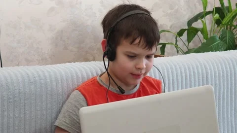 Boy using a laptop playing online games or tablet communicate blogging, studying 库存影片 148632235