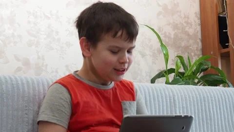 Boy using a laptop playing online games or tablet communicate blogging, studying 库存影片 148632486