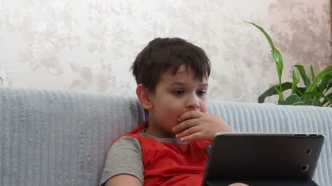 Boy using a laptop playing online games or tablet communicate blogging, studying Vidéo 148632669
