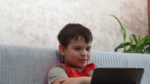 Boy using a laptop playing online games or tablet communicate blogging, studying Stockbeeldmateriaal 148632709