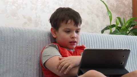 Boy using a laptop playing online games or tablet communicate blogging, studying Vidéo 148632766