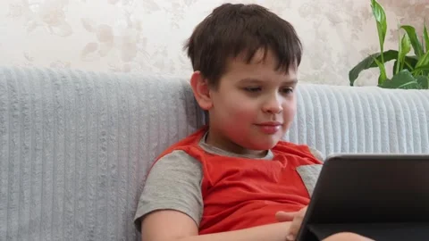Boy using a laptop playing online games or tablet communicate blogging, studying 库存影片 148632828