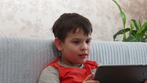 Boy using a laptop playing online games or tablet communicate blogging, studying 库存影片 148632836