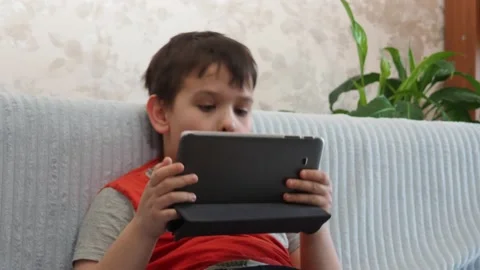Boy using a laptop playing online games or tablet communicate blogging, studying 库存影片 148632887