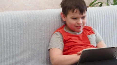 Boy using a laptop playing online games or tablet communicate blogging, studying 库存影片 148632888
