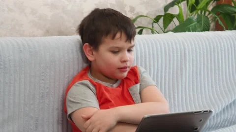 Boy using a laptop playing online games or tablet communicate blogging, studying 库存影片 148632933