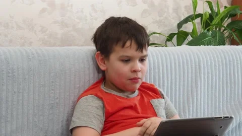 Boy using a laptop playing online games or tablet communicate blogging, studying 库存影片 148633127