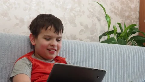 Boy using a laptop playing online games or tablet communicate blogging, studying 库存影片 148633364