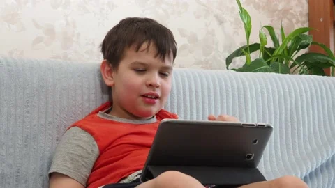 Boy using a laptop playing online games or tablet communicate blogging, studying 库存影片 148633398