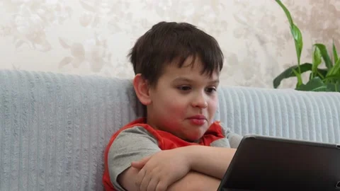 Boy using a laptop playing online games or tablet communicate blogging, studying Stock Footage 148633468