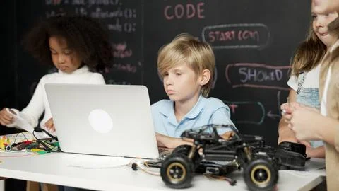 Boy using laptop programing engineering code and writing program. Erudition. 库存照片