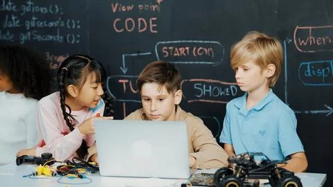 Boy using laptop programing engineering code and writing program. Erudition. Photos