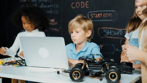 Boy using laptop programing engineering code and writing program. Erudition. 库存照片