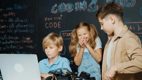 Boy using laptop programing engineering code and writing program. Erudition. Photos