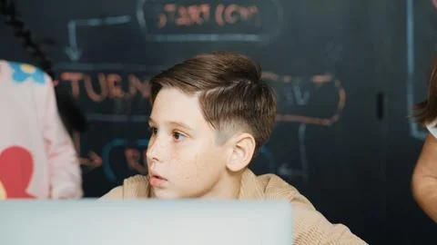 Boy using laptop programing engineering code and writing program. Erudition. Photos