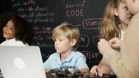 Boy using laptop programing engineering code and writing program. Erudition. Photos