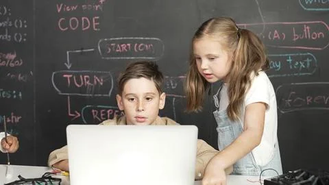 Boy using laptop programing engineering code and writing program. Erudition. Stock Photos