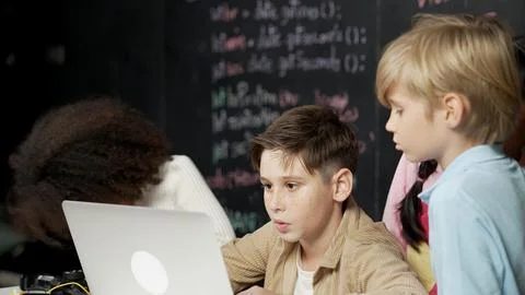 Boy using laptop programing engineering code and writing program. Erudition. Photos