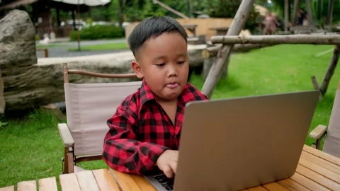 Boy using laptop while attending the online classes in garden. Stock Footage 206076220