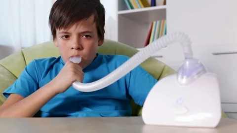 Boy using nebulizer inhaler with mouthpiece Video stock 80353720