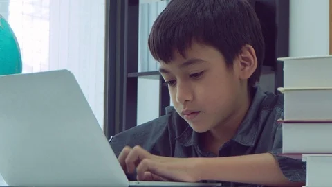Boy using notebook computer at school Stock Footage 105631928