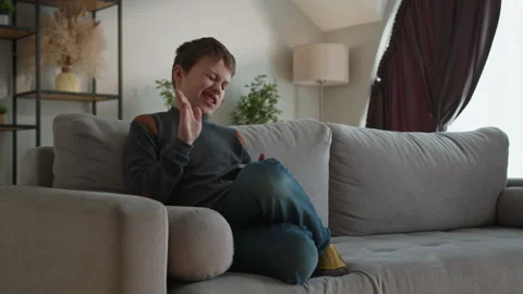 Boy Using Smartphone on Couch. Thoughtful child digital focus relaxed home Stock Footage 335482719