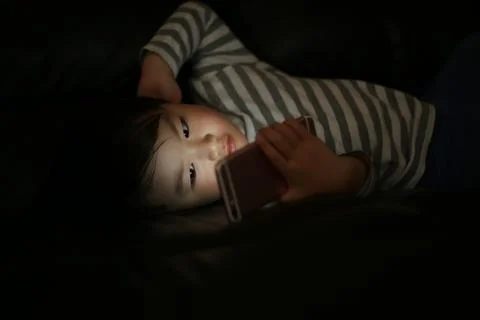 Boy using smartphone in the dark Stock Photos