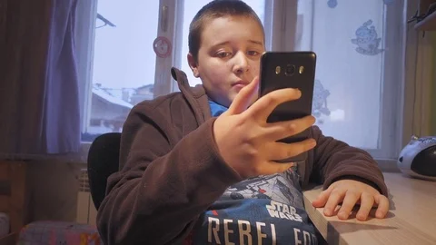 Boy using smartphone 스톡 동영상 73258756