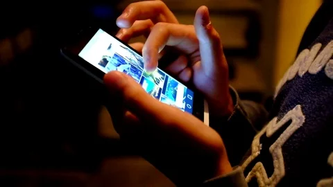 Boy using the smartphone at night Stock Footage 78761085