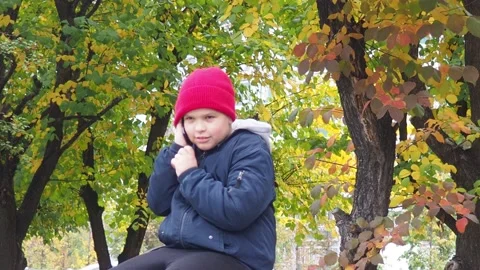 Boy using smartphone in park.  school  boy in casual wear talking on the phone 库存影片 164472341