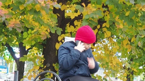 Boy using smartphone in park.  school  boy in casual wear talking on the phone Stock Footage 164472361