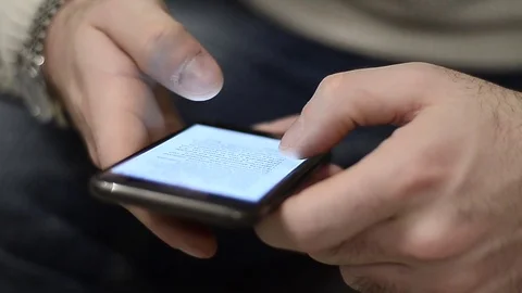 Boy using a smartphone to shop online from home in Milan, Italy Stock Footage 76104677