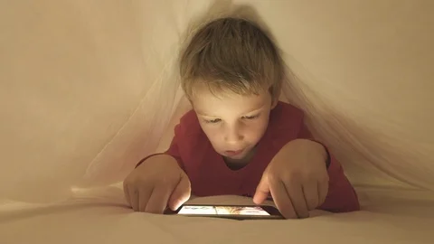 Boy using smartphone to video call a friend Stock Footage 95450080